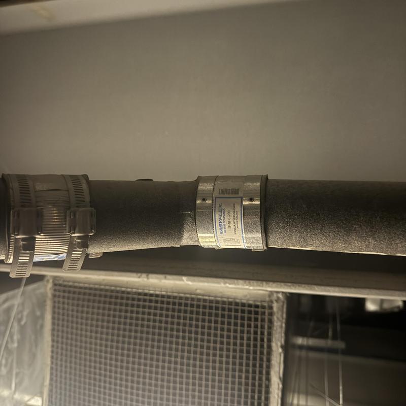 2” cast iron pipe with coupling clamp in ceiling space
