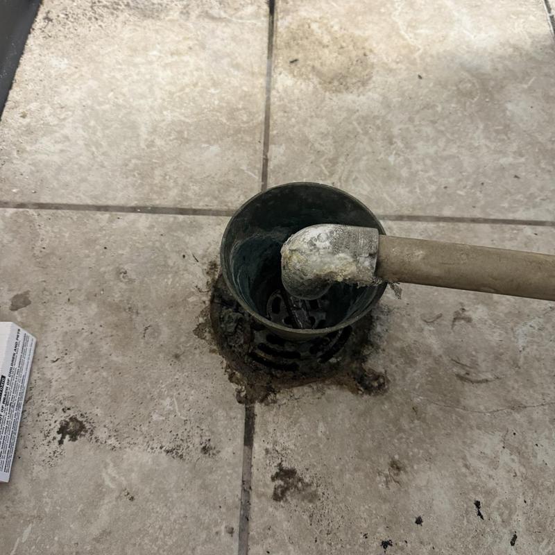 2” cast iron floor drain with corrosion on tile floor