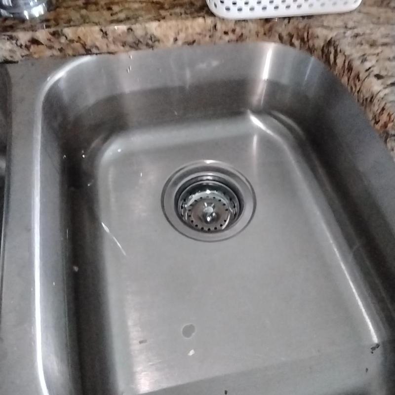 Basket strainer installed in filled stainless steel sink