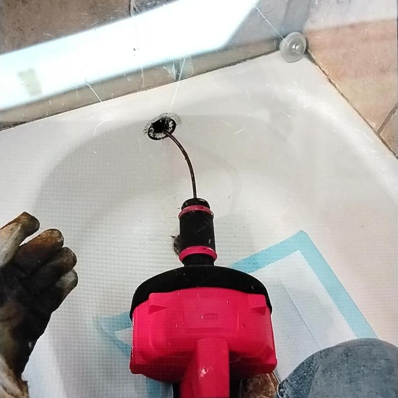 Bathroom tub drain cable clearing with auger tool