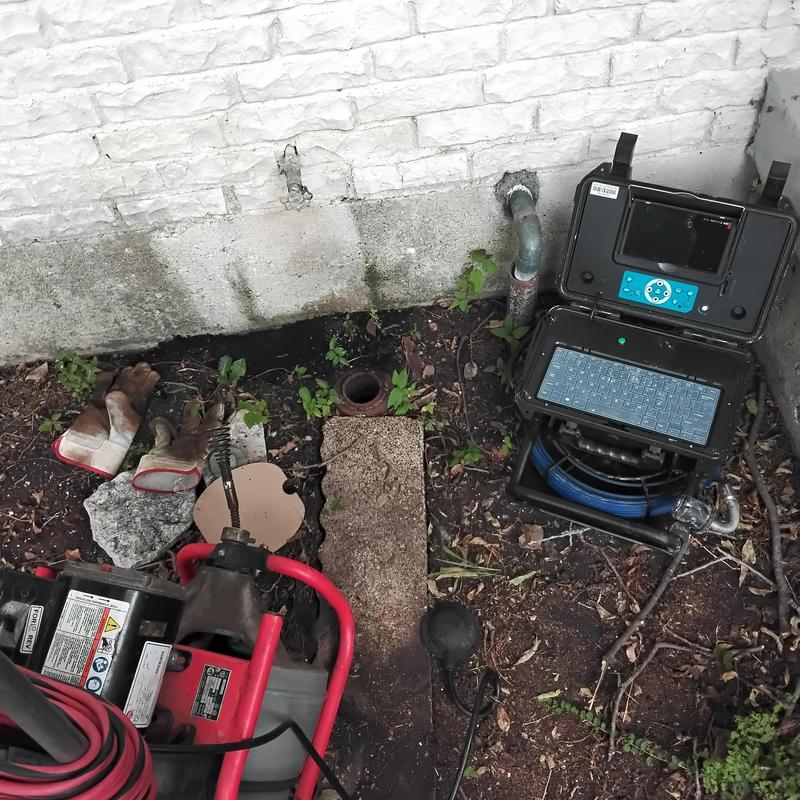 Cast iron sewer pipe cleanout with inspection camera