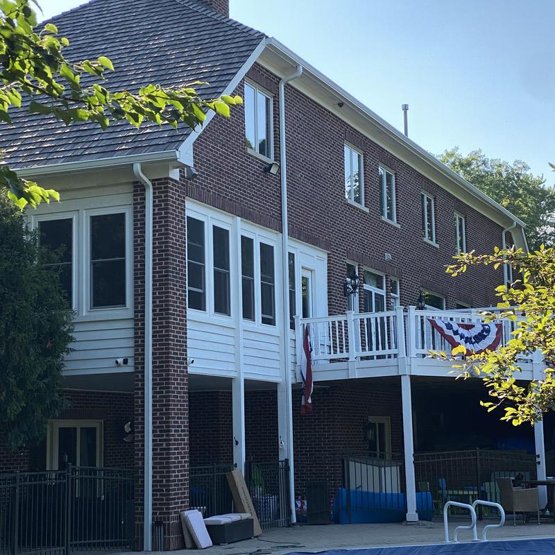 Oversized gutters with gutter guards on brick house