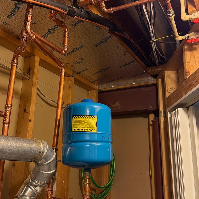 Copper plumbing pipes with blue expansion tank installation Copper plumbing pipes with blue expansion tank installation