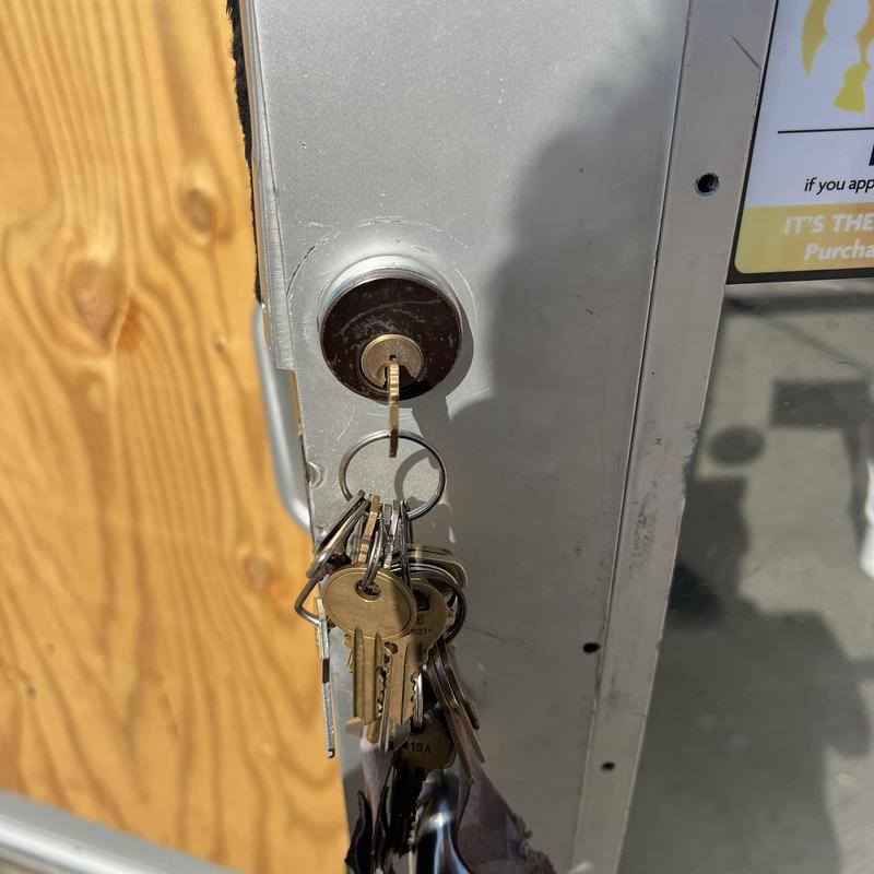 Door lock cylinder with keys in outdoor metal door