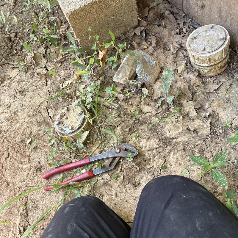 Outdoor water meter with plumber wrench on dirt ground Outdoor water meter with plumber wrench on dirt ground
