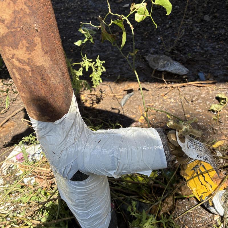 Outdoor yard faucet wrapped with white tape for leak control Outdoor yard faucet wrapped with white tape for leak control