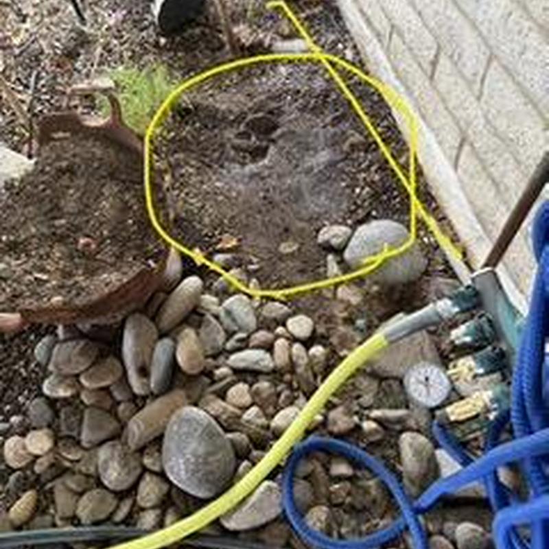 Irrigation valve box with exposed soil in backyard