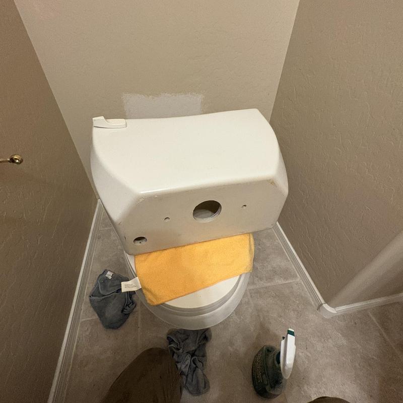 Toilet tank cover removal with tools and towels