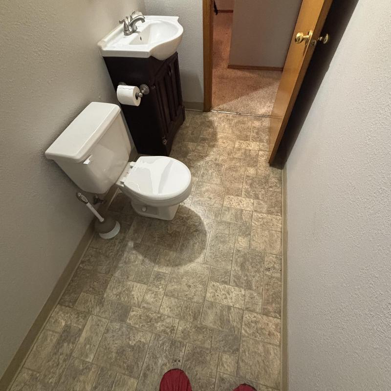 Toilet and sink in small basement bathroom before shower install Toilet and sink in small basement bathroom before shower install