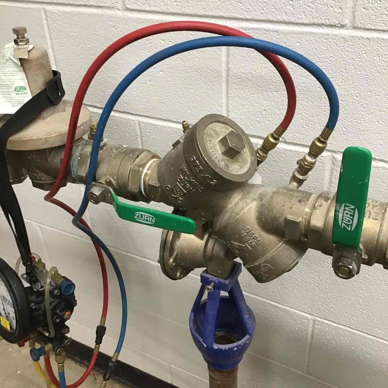 Backflow preventer with testing gauges at commercial site Backflow preventer with testing gauges at commercial site