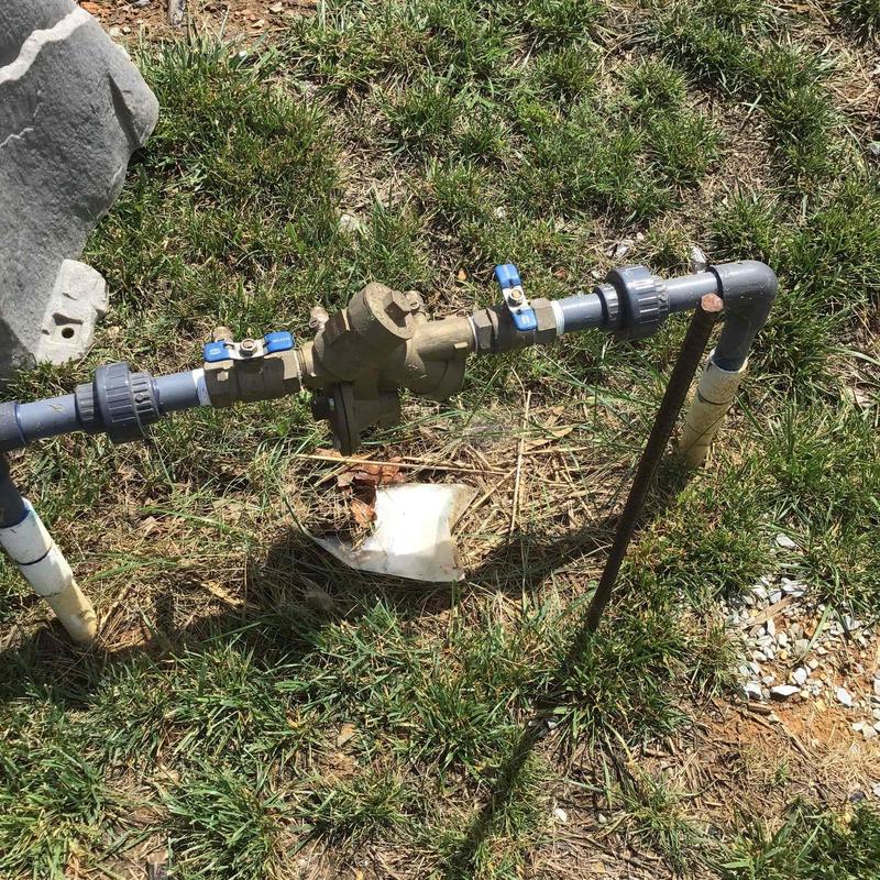 Backflow prevention valve with piping outdoors Backflow prevention valve with piping outdoors