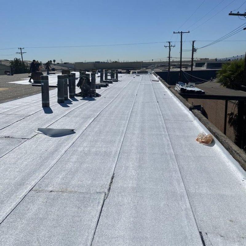 Flat roofing membrane with vent pipes on commercial roof Flat roofing membrane with vent pipes on commercial roof