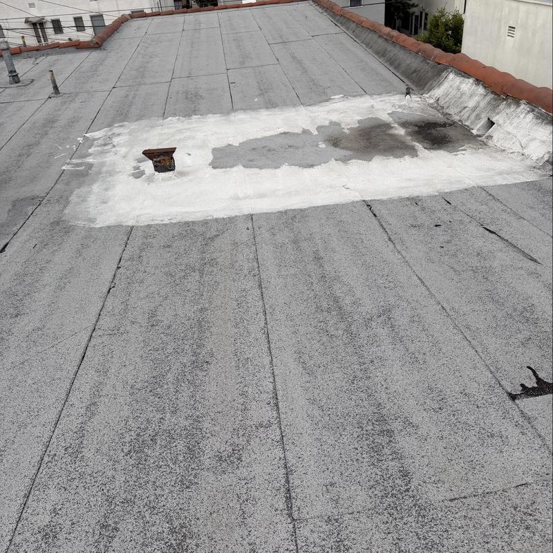 Torch down roofing patch with discoloration and stains Torch down roofing patch with discoloration and stains