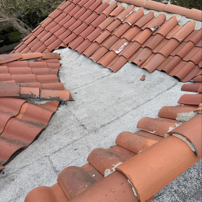 Torch down roofing with damaged tile overlap Torch down roofing with damaged tile overlap
