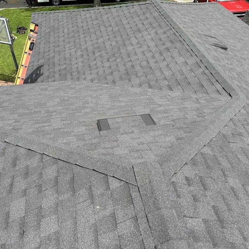 Gray asphalt shingles roof installation with vents Gray asphalt shingles roof installation with vents