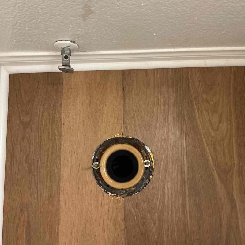 Toilet flange on wood floor with old wax ring residue