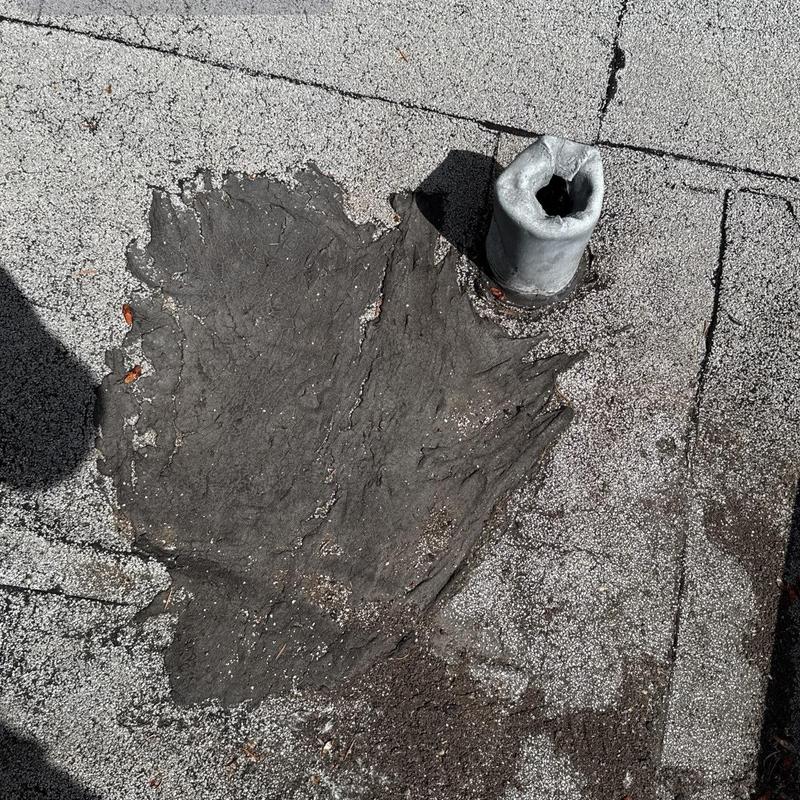Roof vent pipe with deteriorated patching on flat roof Roof vent pipe with deteriorated patching on flat roof