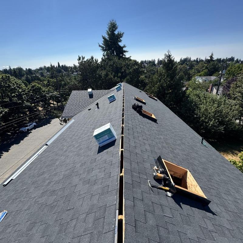 Asphalt shingle roof replacement in progress on residential home