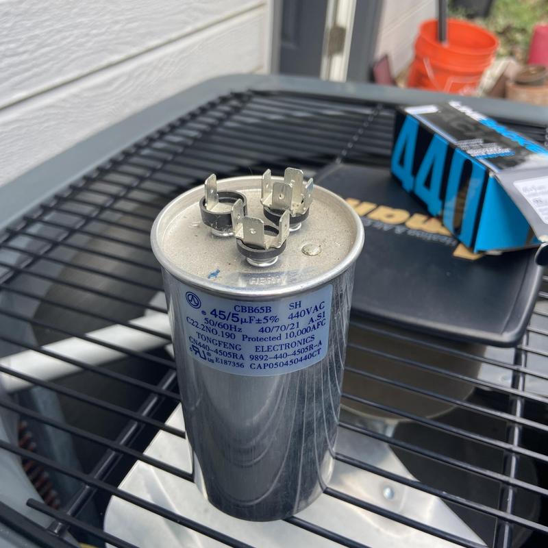 AC capacitor on condenser unit top grille AC capacitor on condenser unit top grille