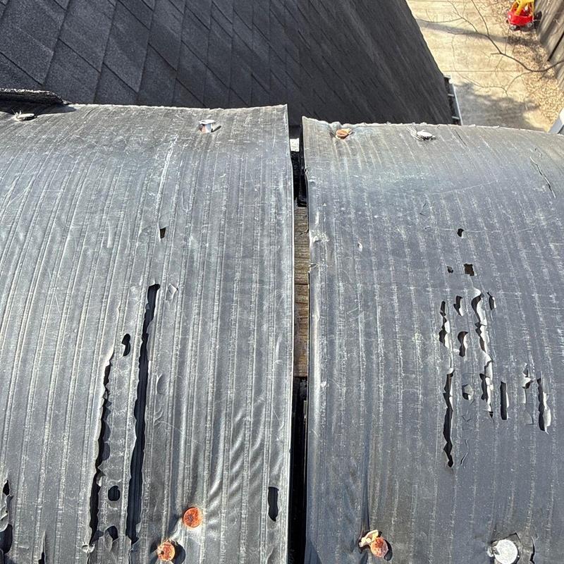 Roofing underlayment with visible hail damage and tears