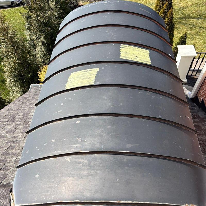 Metal curved roof panels with hail damage patches