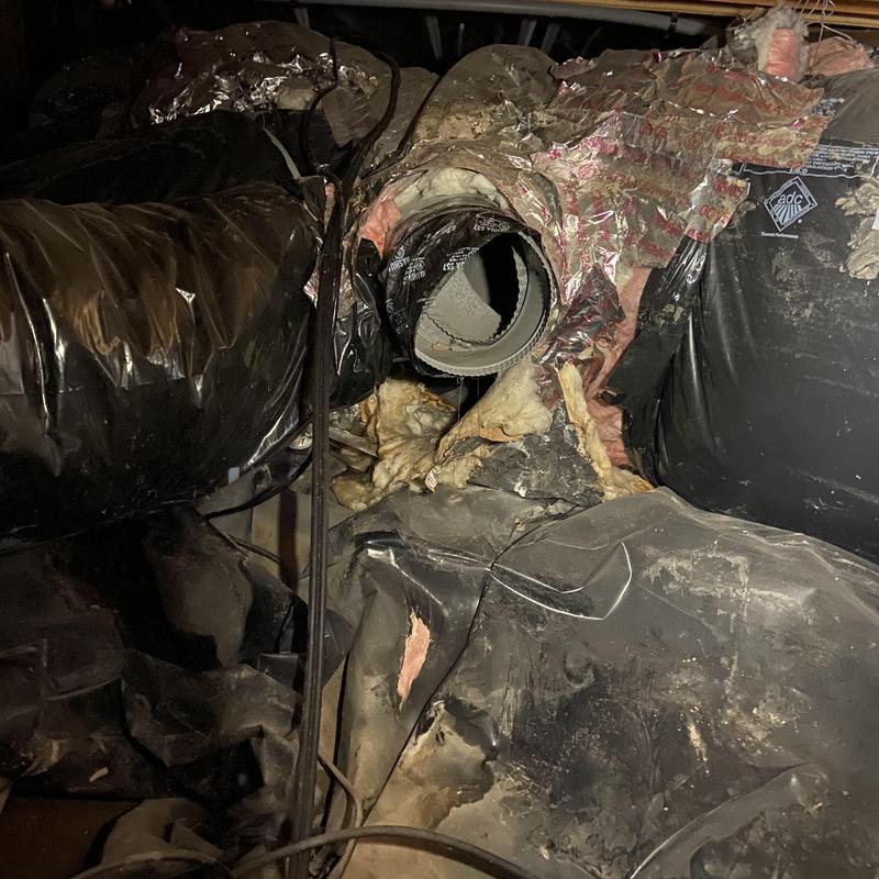Ductwork with torn insulation in crawl space Ductwork with torn insulation in crawl space