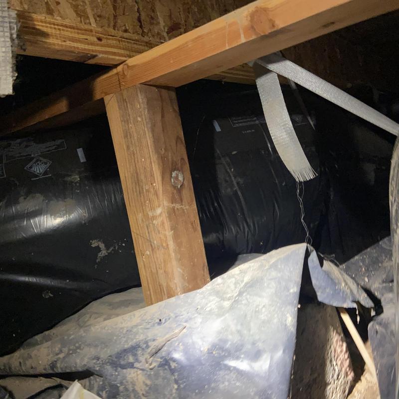 Ductwork in crawl space with support beams and straps Ductwork in crawl space with support beams and straps