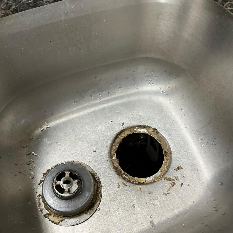 Basket strainer and drain opening in stainless steel sink