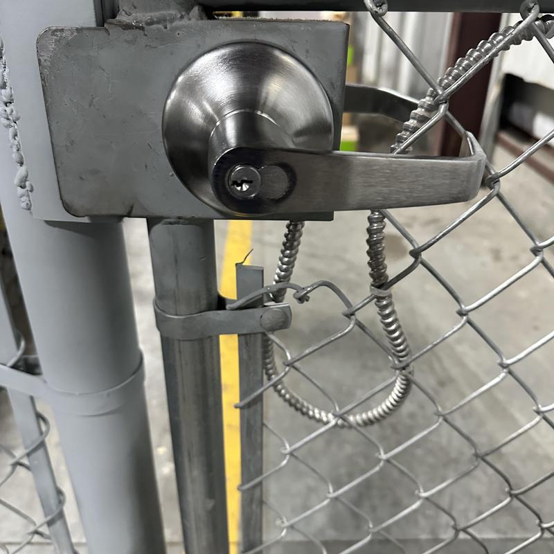 Interchangeable core cylinder on chain-link fence door