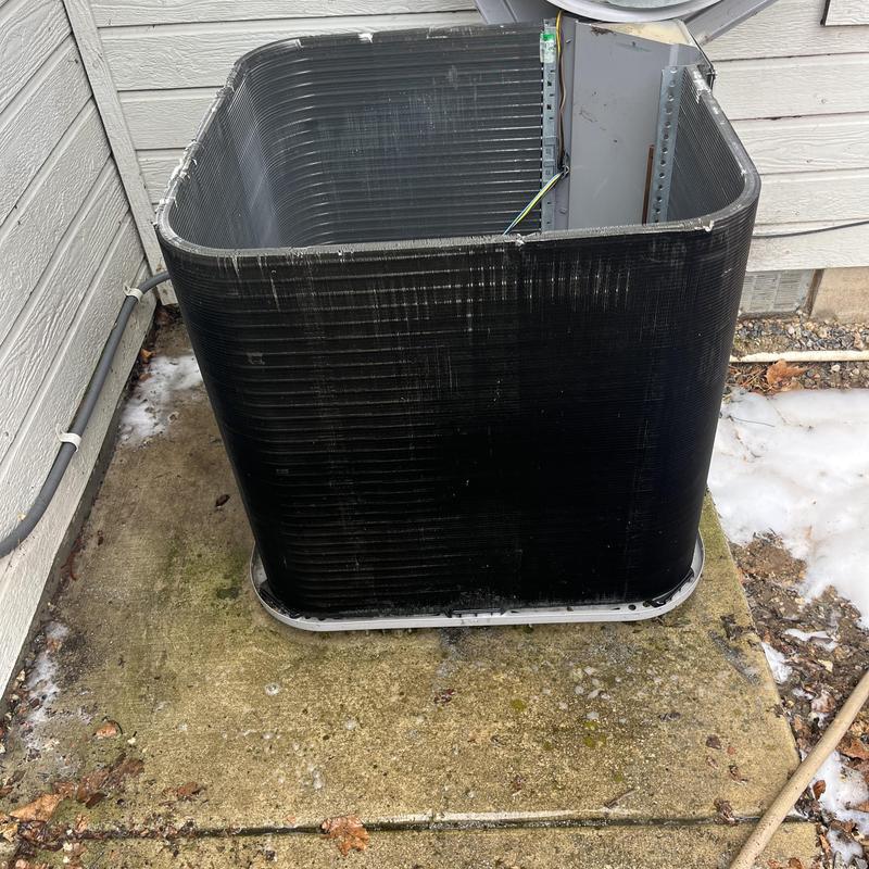 HVAC condenser coil with removed components outdoors HVAC condenser coil with removed components outdoors