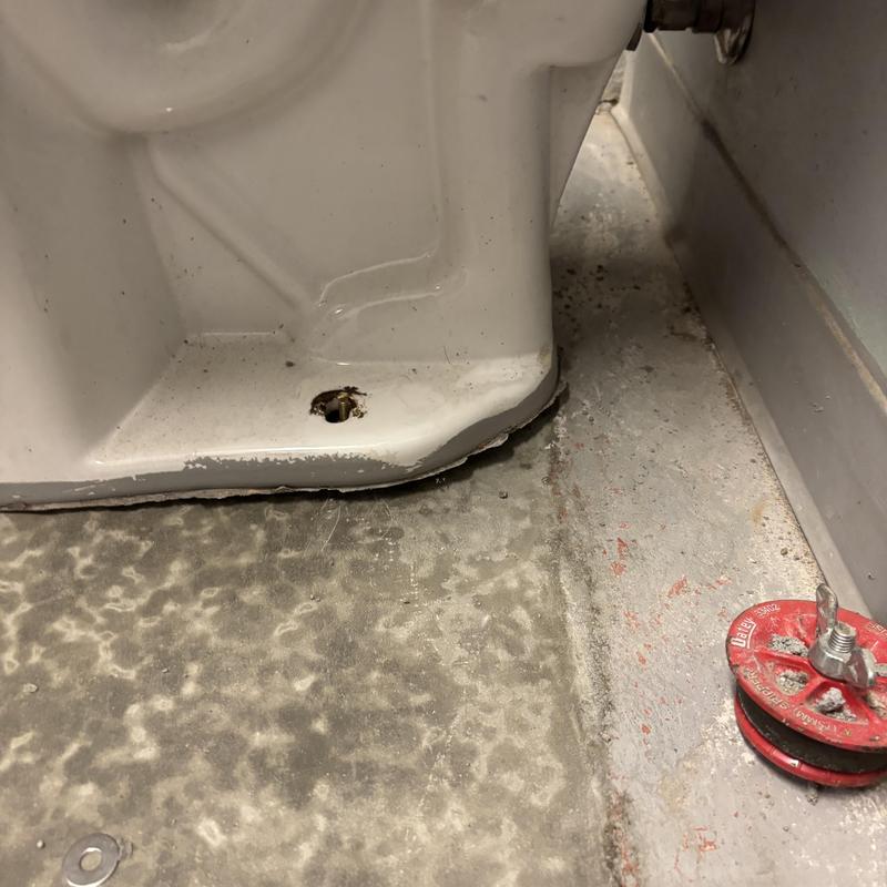 Toilet base flange with missing bolts and wax ring residue Toilet base flange with missing bolts and wax ring residue