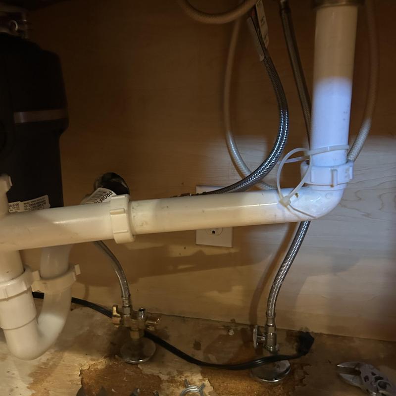 Sink drain pipes with leak repair and water lines under cabinet Sink drain pipes with leak repair and water lines under cabinet