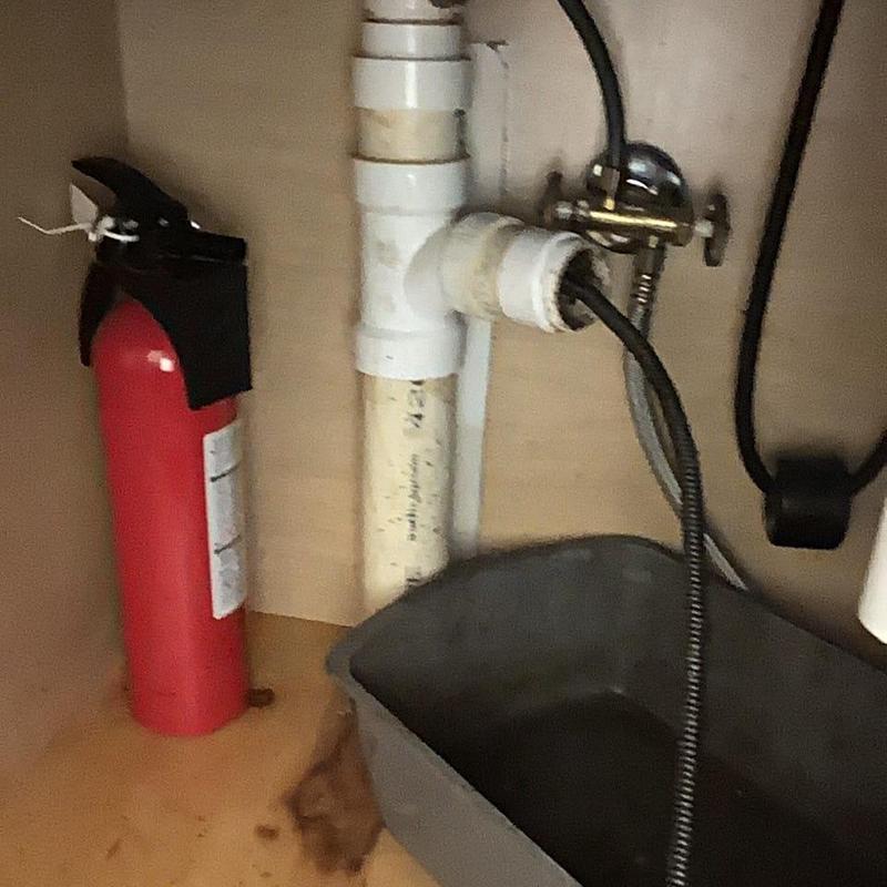 Sink drain pipe with cable auger in cabinet Sink drain pipe with cable auger in cabinet