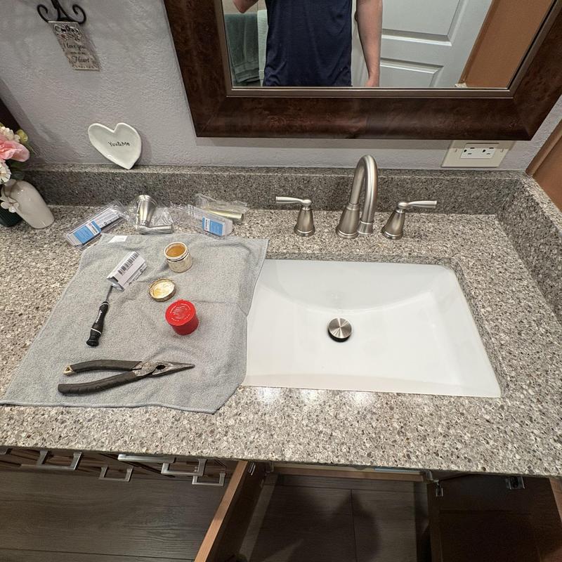 Lavatory faucet cartridge installation tools on counter