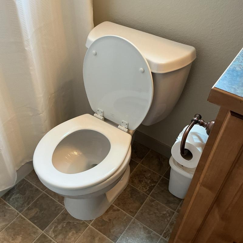 Toilet replacement with open lid in bathroom corner Toilet replacement with open lid in bathroom corner