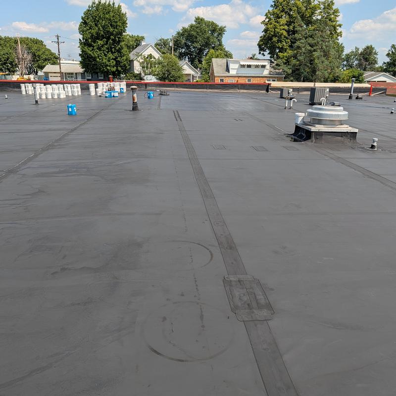 Flat commercial roof with elastomeric restoration coating