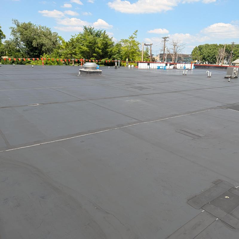 Flat commercial roof with elastomeric coating applied