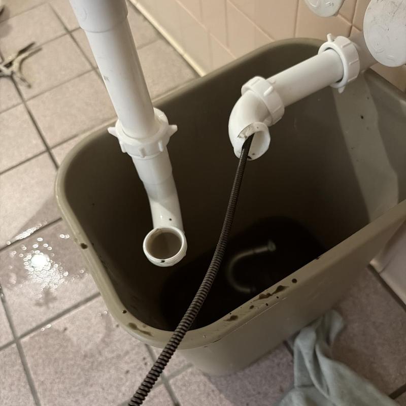 Bathroom sink drain with cleaning snake tool Bathroom sink drain with cleaning snake tool
