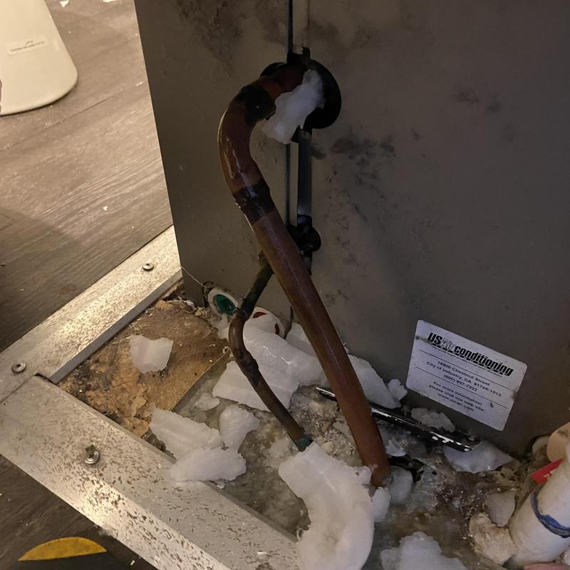 Air conditioner evaporator coil pipe with ice buildup Air conditioner evaporator coil pipe with ice buildup