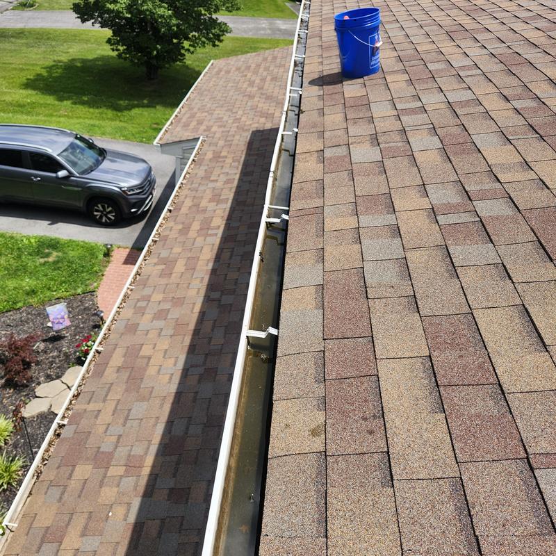 Gutter cleaning and maintenance on residential roof