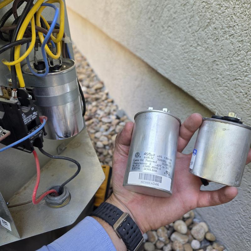 Air conditioner voltage capacitors replacement in hand