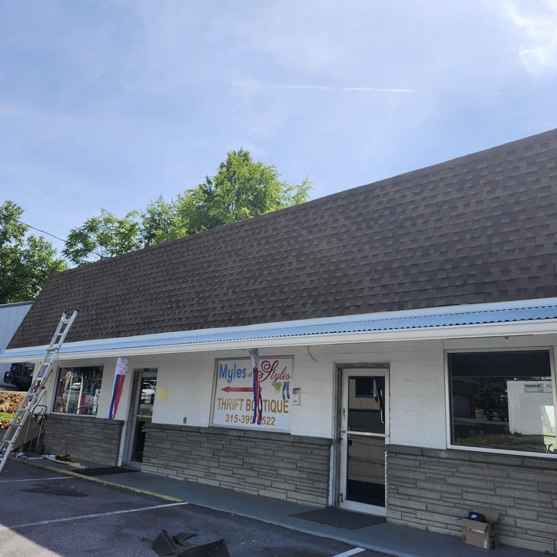 Metal roofing and shingle roof on commercial building
