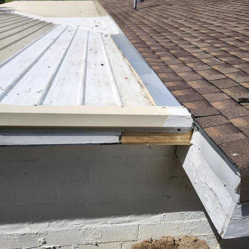 Metal roofing and shingle roof transition on flat area