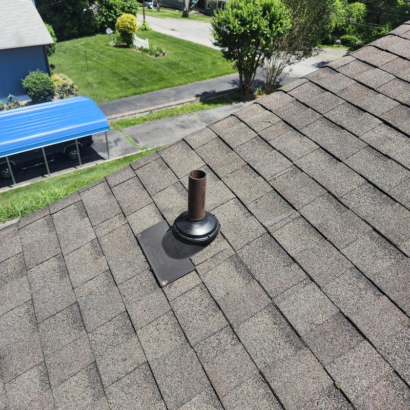 Asphalt shingle roof with vent pipe flashing inspection