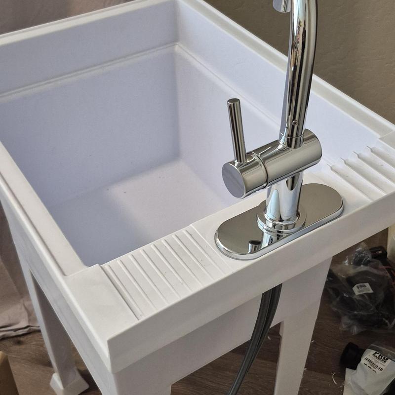 Laundry utility sink with chrome faucet installation