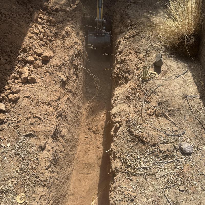 Sewer line trench digging with excavator in Scottsdale Sewer line trench digging with excavator in Scottsdale