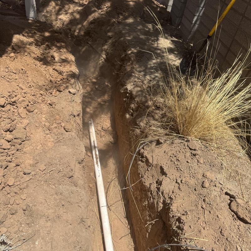 Sewer line trench excavation in dry soil Sewer line trench excavation in dry soil