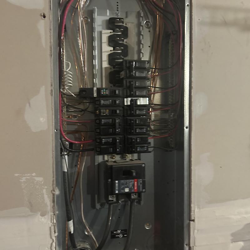 Main electrical service panel with circuit breakers and wiring