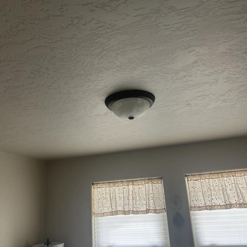 Ceiling light fixture on textured ceiling in living room