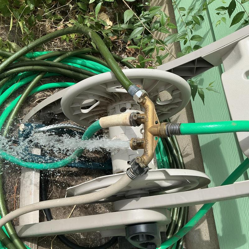 Irrigation valve with leaking garden hoses and reel